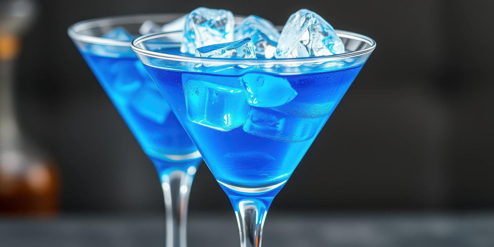 Bright blue cocktails with ice served in elegant glassware at a stylish bar during a night out with friends